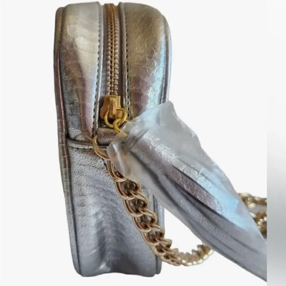 Victoria’s Secret silver snake skin purse with gold chain strap.